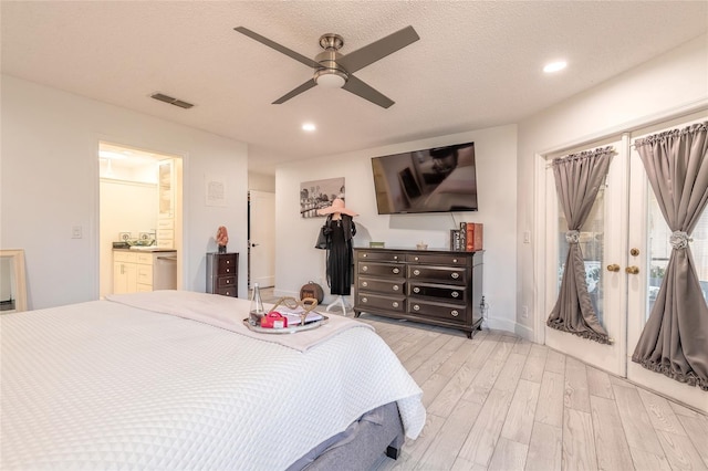 bedroom with a textured ceiling, recessed lighting, visible vents, and light wood-type flooring