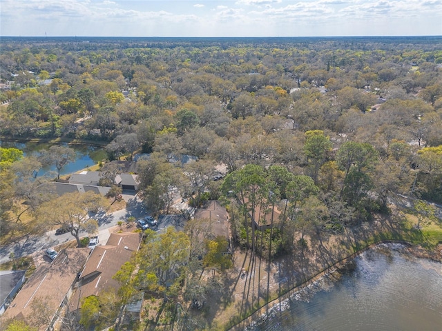 drone / aerial view with a water view and a wooded view