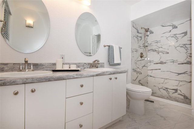 bathroom with a sink, toilet, marble finish floor, and double vanity