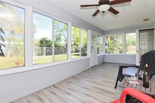 sunroom with a ceiling fan, a healthy amount of sunlight, and visible vents