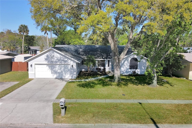 single story home with a front yard, concrete driveway, fence, and a garage