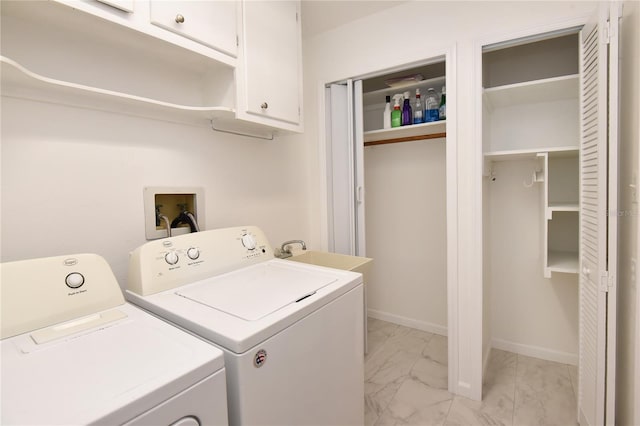 clothes washing area featuring baseboards, cabinet space, a sink, washer and dryer, and marble finish floor