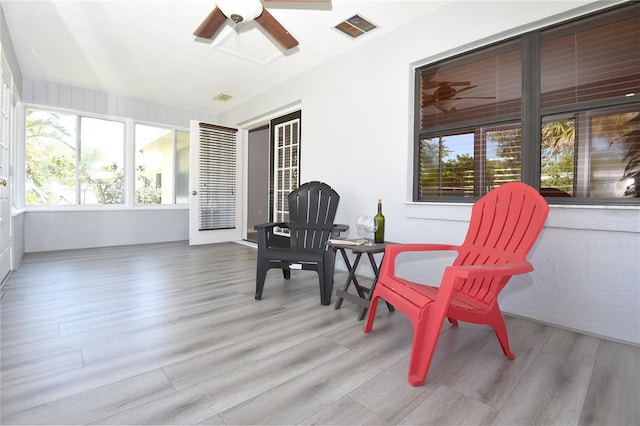 sunroom featuring visible vents and ceiling fan