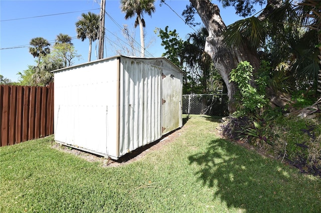 view of shed with a fenced backyard