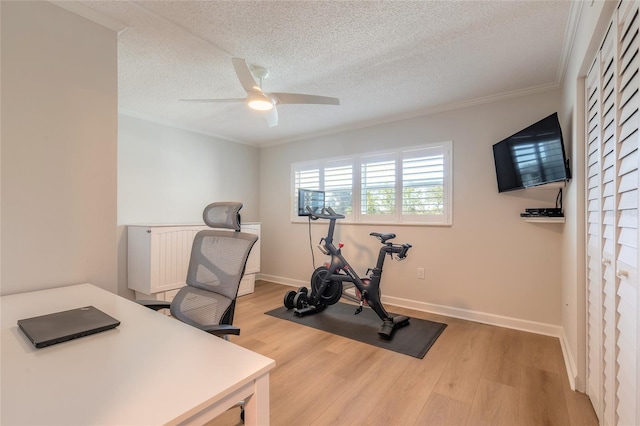 home office with baseboards, ornamental molding, ceiling fan, a textured ceiling, and light wood-type flooring