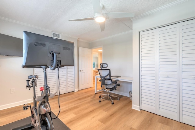 home office with visible vents, ornamental molding, a textured ceiling, wood finished floors, and ceiling fan