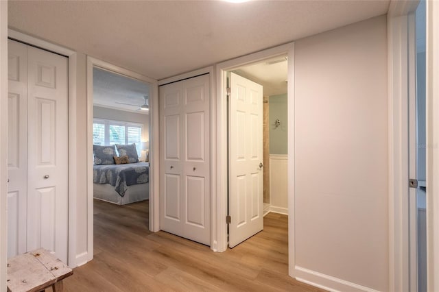 corridor featuring light wood-style flooring