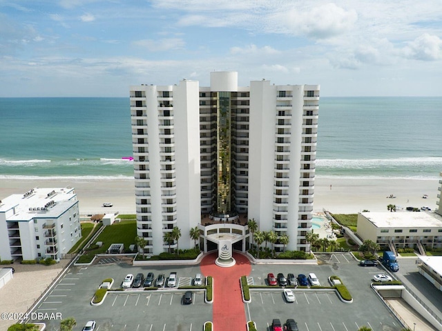 drone / aerial view with a beach view and a water view