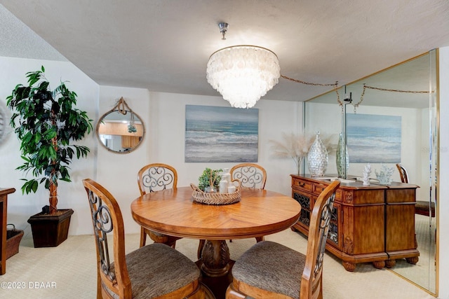 dining room with carpet floors and a chandelier