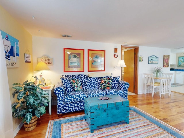 living room with visible vents and wood finished floors