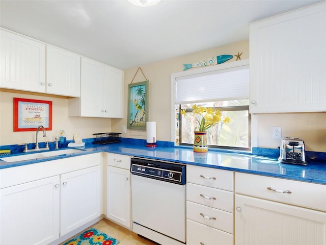 kitchen with a sink, white cabinets, and white dishwasher