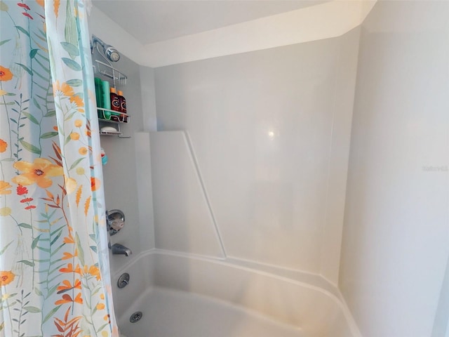 bathroom featuring shower / tub combo with curtain