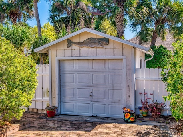 detached garage featuring fence