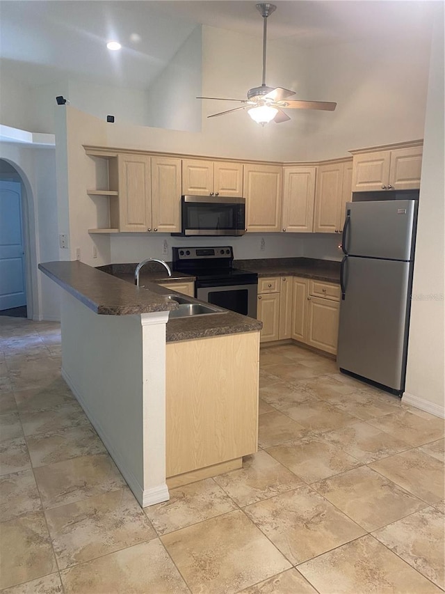 kitchen with light brown cabinets, a sink, open shelves, and stainless steel appliances