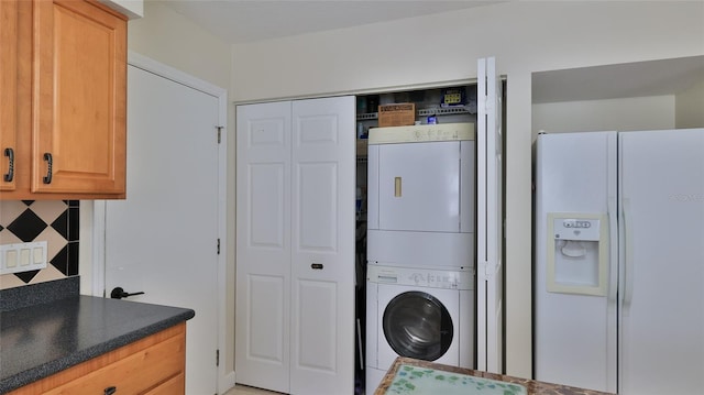 laundry room featuring laundry area and stacked washer and clothes dryer