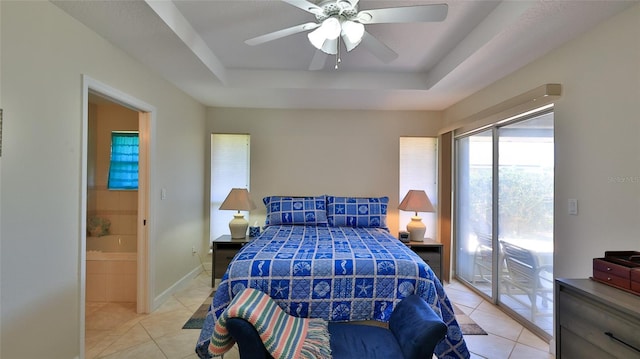 bedroom with access to exterior, ceiling fan, baseboards, light tile patterned flooring, and a raised ceiling