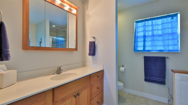 full bath with toilet, a shower with door, tile patterned flooring, baseboards, and vanity