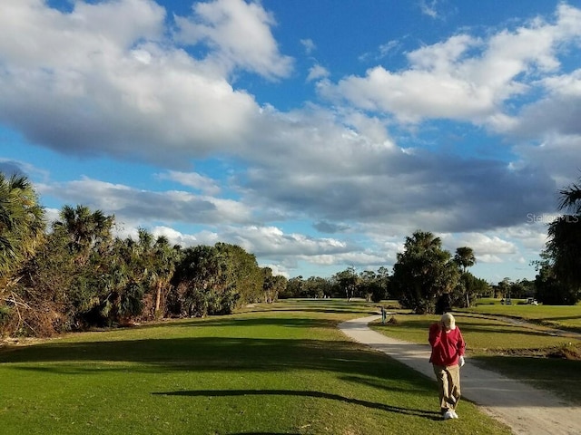 view of community with a yard and golf course view