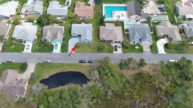 drone / aerial view with a water view and a residential view