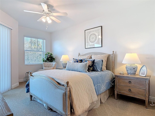 carpeted bedroom with baseboards and a ceiling fan