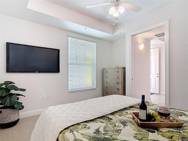 carpeted bedroom featuring baseboards, visible vents, and ceiling fan