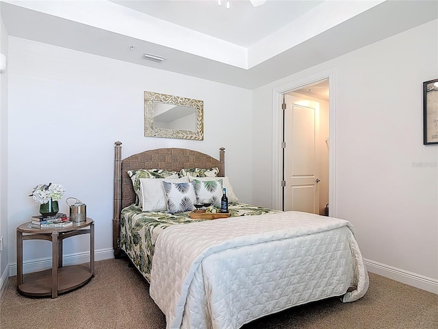 carpeted bedroom with visible vents and baseboards