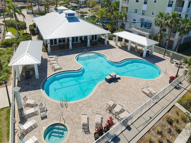 community pool featuring a gazebo, a community hot tub, a patio, and fence