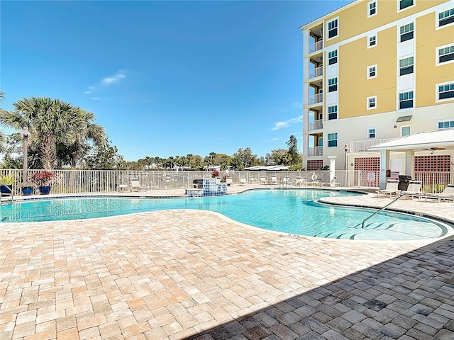 community pool featuring a patio area and fence