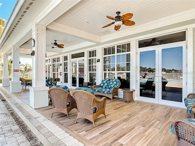 exterior space featuring french doors, beam ceiling, ceiling fan, and ornate columns