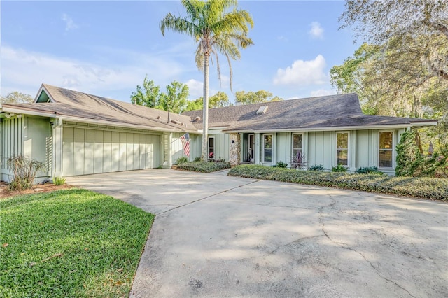 550 Bottlebrush Ct, New Smyrna Beach, FL 32168 - ranch-style home featuring driveway, a garage, and board and batten siding