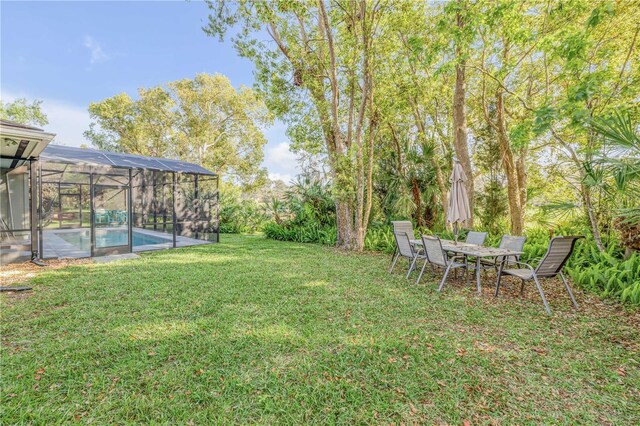 550 Bottlebrush Ct, New Smyrna Beach, FL 32168 - view of green lawn featuring an outdoor pool and glass enclosure