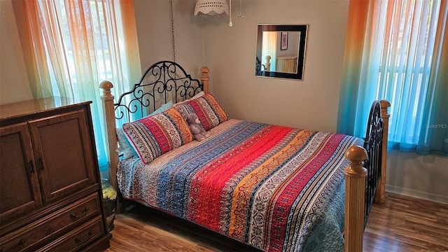 919 Fairvilla Dr, New Smyrna Beach, FL 32168 - bedroom featuring multiple windows and wood finished floors