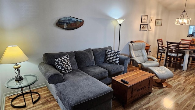 919 Fairvilla Dr, New Smyrna Beach, FL 32168 - living area featuring an inviting chandelier, wood finished floors, and baseboards