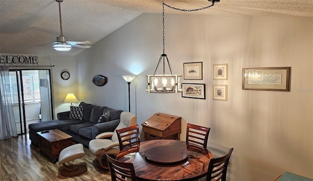 919 Fairvilla Dr, New Smyrna Beach, FL 32168 - dining room with lofted ceiling, a textured ceiling, wood finished floors, and ceiling fan with notable chandelier
