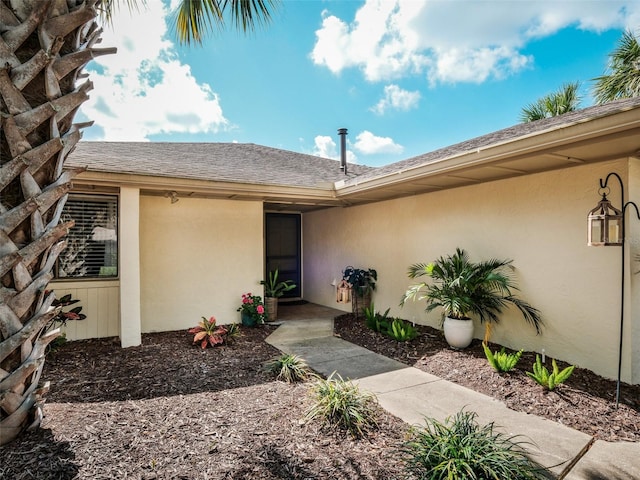 168 Turnberry Cir, New Smyrna Beach, FL 32168 - entrance to property with roof with shingles and stucco siding