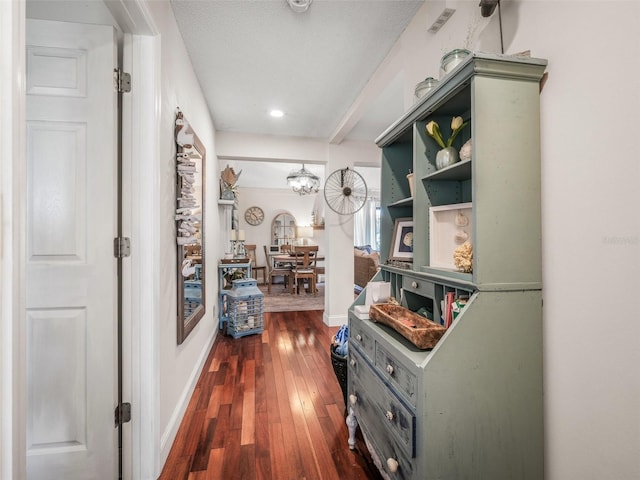 168 Turnberry Cir, New Smyrna Beach, FL 32168 - corridor featuring baseboards, an inviting chandelier, and dark wood finished floors