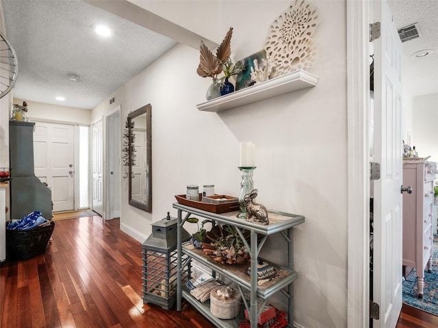 168 Turnberry Cir, New Smyrna Beach, FL 32168 - corridor with baseboards, dark wood-style floors, visible vents, and a textured ceiling