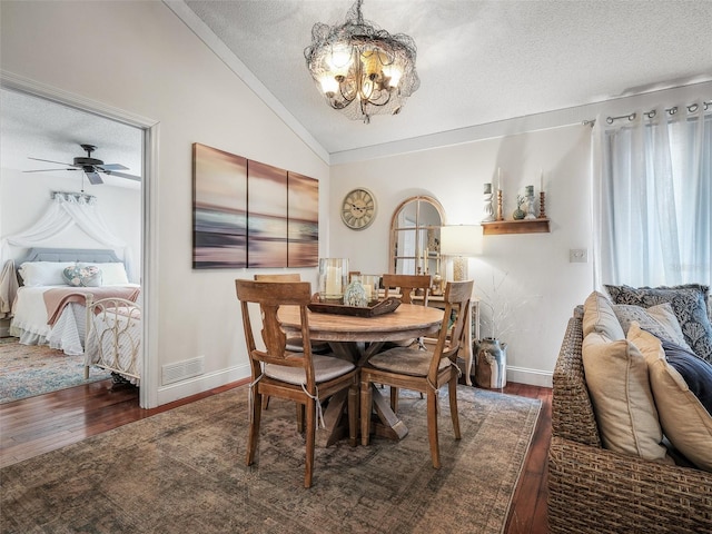 168 Turnberry Cir, New Smyrna Beach, FL 32168 - dining room with lofted ceiling, hardwood / wood-style flooring, visible vents, and a textured ceiling