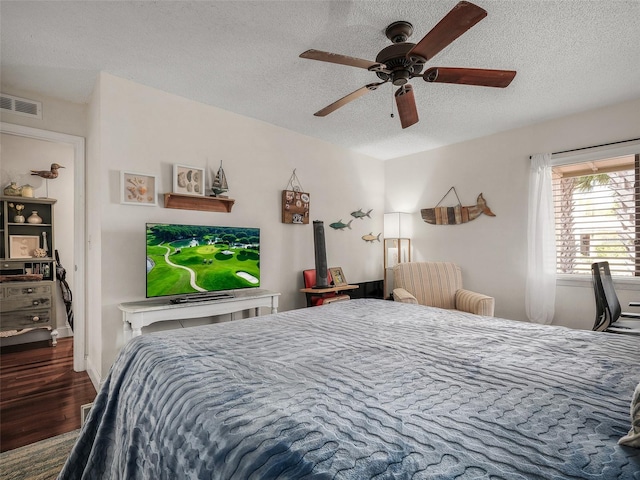168 Turnberry Cir, New Smyrna Beach, FL 32168 - bedroom featuring ceiling fan, visible vents, a textured ceiling, and wood finished floors