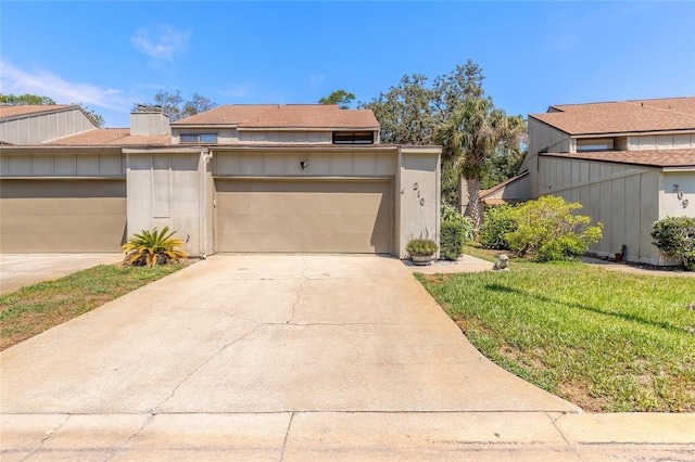 210 Pine Cone Trl, Ormond Beach, FL 32174 - view of front of house with driveway, a front yard, and a chimney