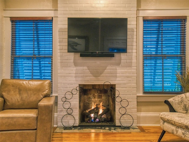 536 Faulkner St, New Smyrna Beach, FL 32168 - living area featuring baseboards, a fireplace, and wood finished floors