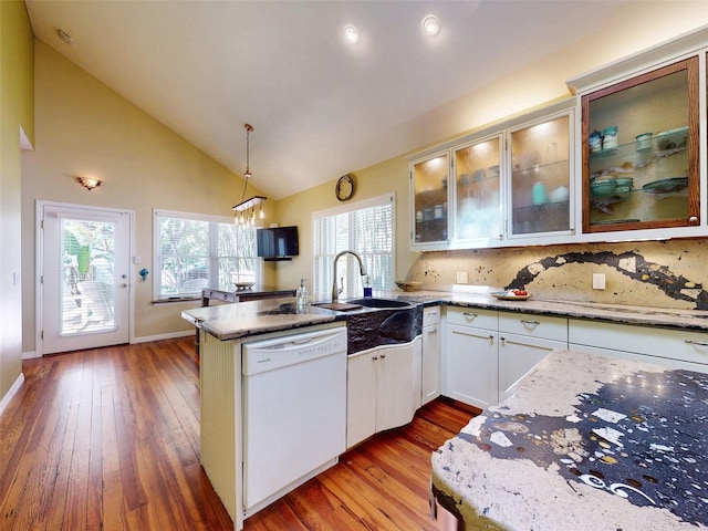 536 Faulkner St, New Smyrna Beach, FL 32168 - kitchen featuring a peninsula, white cabinetry, a sink, white dishwasher, and wood-type flooring
