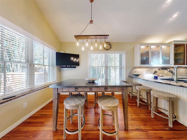 536 Faulkner St, New Smyrna Beach, FL 32168 - kitchen featuring lofted ceiling, wood finished floors, and plenty of natural light