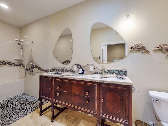536 Faulkner St, New Smyrna Beach, FL 32168 - bathroom featuring a sink, double vanity, toilet, and tiled shower