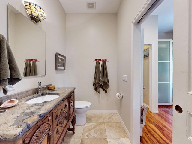 536 Faulkner St, New Smyrna Beach, FL 32168 - bathroom featuring baseboards, visible vents, toilet, and vanity