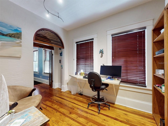 536 Faulkner St, New Smyrna Beach, FL 32168 - home office featuring baseboards, track lighting, and wood-type flooring