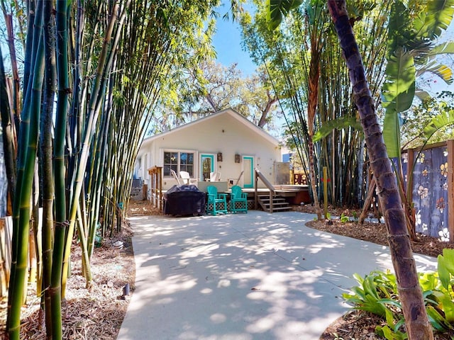 536 Faulkner St, New Smyrna Beach, FL 32168 - rear view of house with fence, a deck, and a patio area