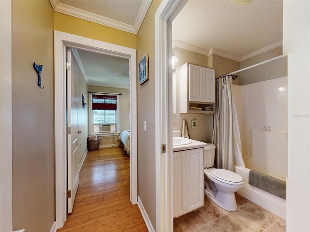 536 Faulkner St, New Smyrna Beach, FL 32168 - full bath with ornamental molding, toilet, wood finished floors, vanity, and shower / bathtub combination with curtain