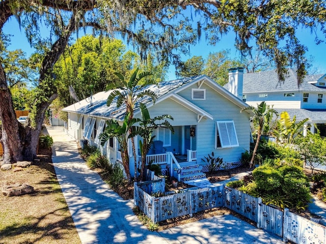 536 Faulkner St, New Smyrna Beach, FL 32168 - view of front of home featuring a porch and a fenced front yard