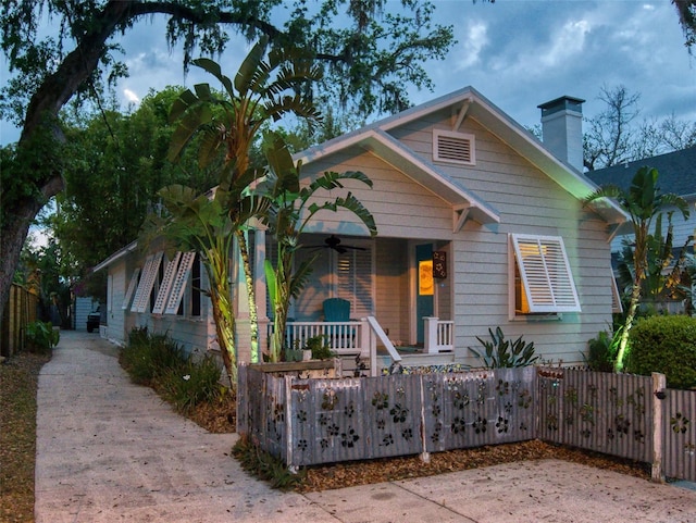 536 Faulkner St, New Smyrna Beach, FL 32168 - bungalow with covered porch, a fenced front yard, a chimney, and ceiling fan